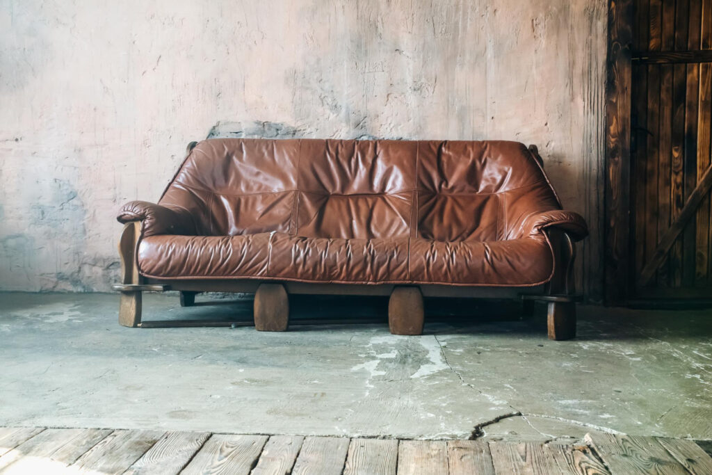 Old Brown leather sofa in loft design apartment