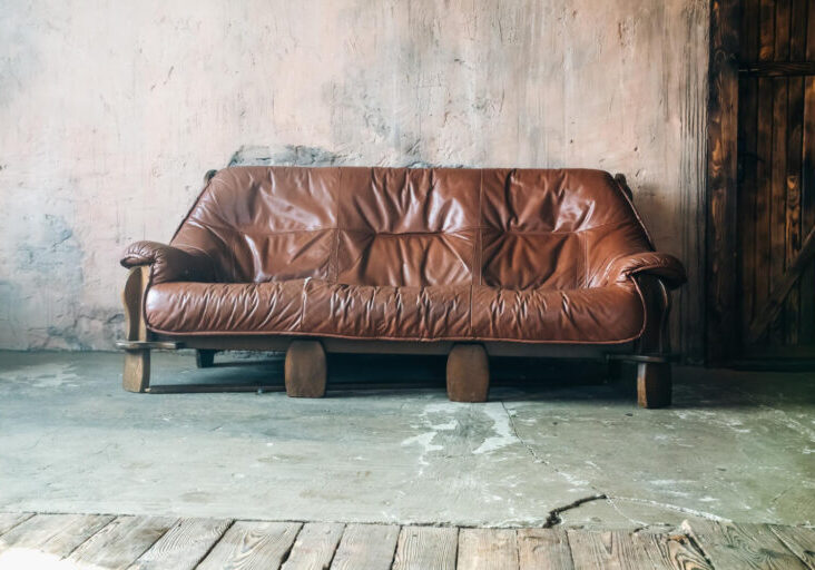 Old Brown leather sofa in loft design apartment